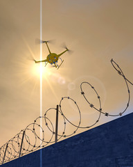 3D illustration of a UAV drone patrolling along a concrete wall with barbed wire. Fictitious drone, motion blur for dramatic effect.