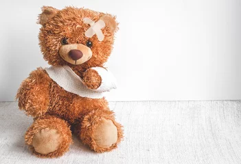 Fotobehang concept teddy bear childhood diseases at textile background © 279photo