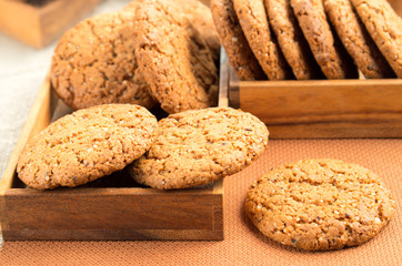 A lot of oatmeal cookies in two wooden boxes