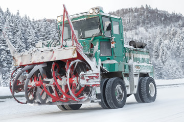 machine cleans snow from the road