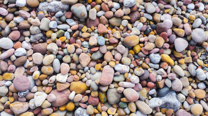 Background with colored stones on a beach