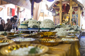jasmin garland on a silver tray consecrated Buddha inside the