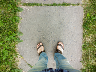 Feet on the pavement.