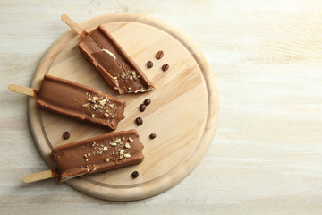 Classic chocolate ice cream with nuts on a wooden Boards.