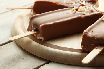 Classic chocolate ice cream with nuts on a wooden Boards.