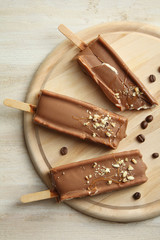 Classic chocolate ice cream with nuts on a wooden Boards.