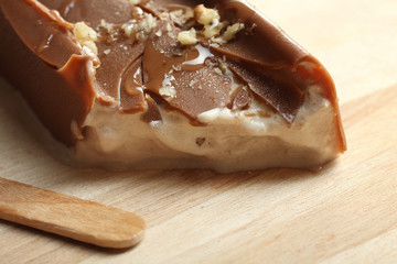 Classic chocolate ice cream with nuts on a wooden Boards.