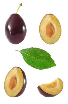 Collection of whole and sliced plum fruits and leaf on white background with clipping path