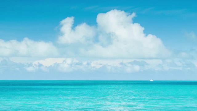 Little White Boat on Vast Tropical Ocean Waters in Bermuda with a Blue Sky Full of White Clouds on a Sunny Day