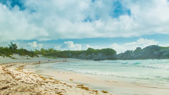 Wide Angle View of Tropical Horseshoe Bay Beach with Small Waves Breaking onto Pink Sand