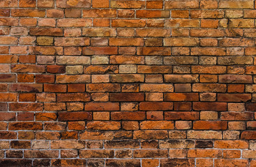 An ancient reddish brick wall closeup