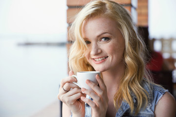 Beautiful girl drinking coffee in cafe