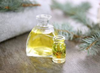Obraz na płótnie Canvas Bottles of pine essential oil on wooden table
