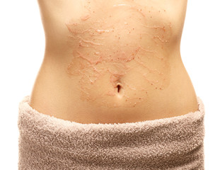 Closeup view of beautiful female body with applied scrub, on white background