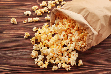 Tasty traditional popcorn on wooden background