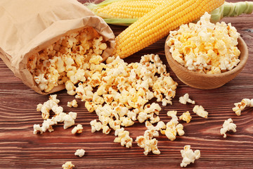 Tasty traditional popcorn on wooden background