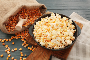Pan full of traditional popcorn on wooden board
