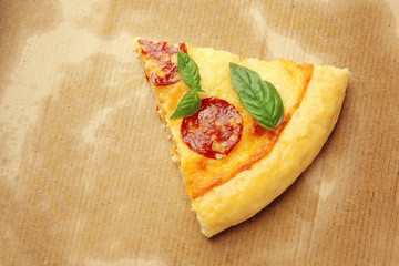 Slice of pepperoni pizza on cardboard