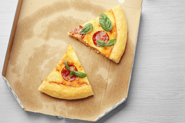 Slices of pepperoni pizza on cardboard