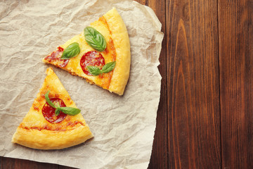 Slices of pepperoni pizza on paper