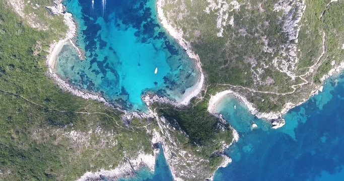Porto Timoni Corfu Island, famous for it's beach shape and clear blue waters. Aerial video from a drone.