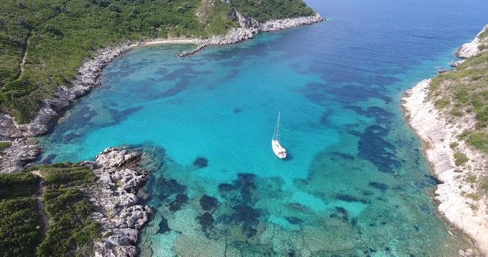 Porto Timoni Corfu Island, famous for it's beach shape and clear blue waters. Aerial video from a drone.