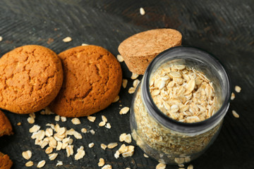 Oatmeal cookies with groats on wooden background
