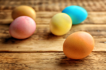 Colourful Easter eggs on wooden background