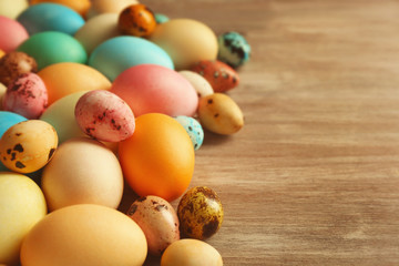 Colourful Easter eggs on wooden background