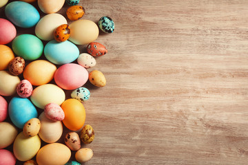 Colourful Easter eggs on wooden background