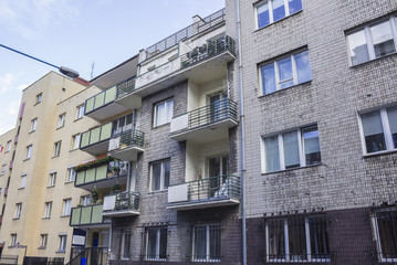 Houses built in the twenties and thirties of the twentieth century in city Warsaw, Poland. Residential multi-storey building, faced with gray bricks..