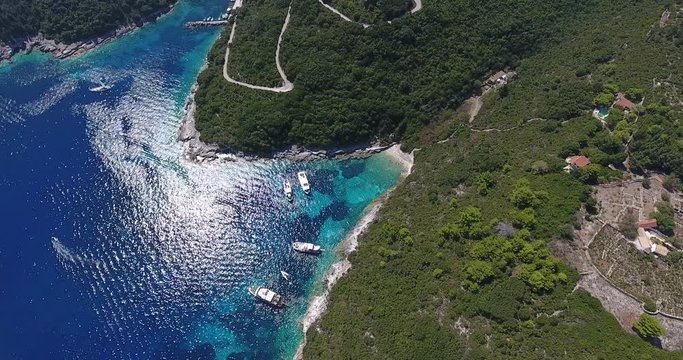 Antipaxos bay near Paxos island Corfu,, Kerykra, Greece. Aerial video from a drone with boats and tourists swimming in water