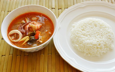 boiled seafood and pork tom yum Thai spicy soup eat with rice