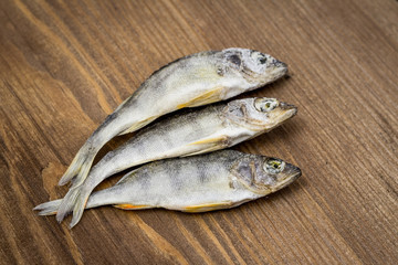 Dried fish on wooden background