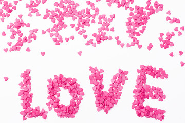 the "love" of many small hearts on a white background. Festive background for Valentine's day, birthday, wedding, holiday