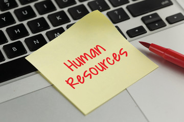 Human Resources sticky note pasted on the keyboard