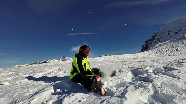 Slow motion: Young man is having fun on sunny winter day, Tignes, France