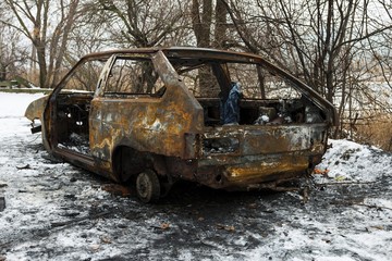 Burned car after a fire happened in winter park. Stock image.