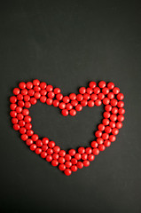 Red candy Heart shape over black gackground