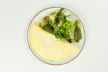 omelette with salad on white background