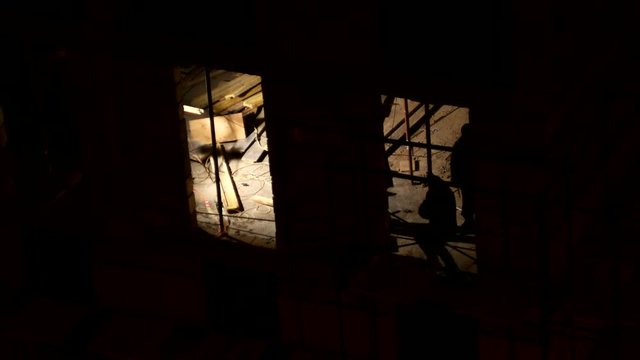 ODINTSOVO, RUSSIA - December 02, 2015. Timelapse clip of building construction. Workers in orange uniform build an apartment building. Winter evening.