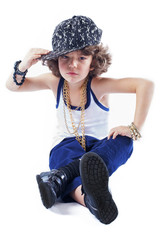 Funny Kinky rapper sitting on the floor holding his hand over the visor baseball cap looking at the camera. White background.