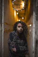 Obraz premium Young blonde woman posing in the dark corridor with lights