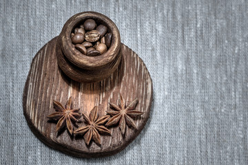 coffee, star anise, cinnamon, wooden utensils on linen background