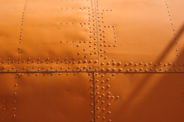 orange texture covering aircraft rivets for background