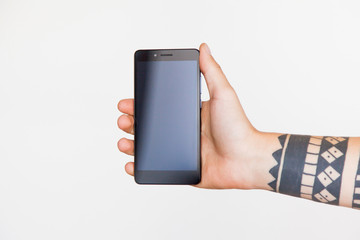 Male hand with a tattoo holding smartphone on white background. Branding Mock-Up.