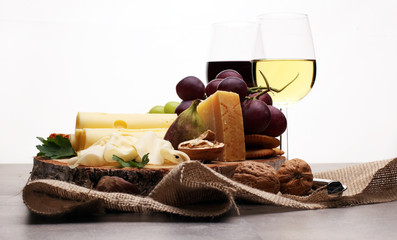 Bottle of white wine, grape and corks on wooden table