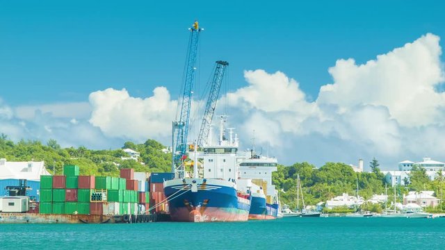 Cargo Shipping in the Tropical Islands with Vessels Docked in Hamilton Harbour in Bermuda with Cranes and Shipping Containers Feeding the Island's Economy.