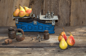 Yellow pear weigh on the old scale, ripe pears, food for sale, small business, agriculture,