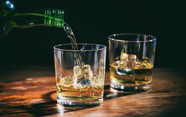 Pouring whiskey in glasses